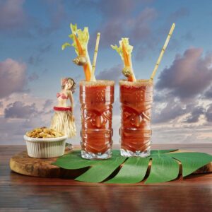 two tiki glasses with bloody mary's.