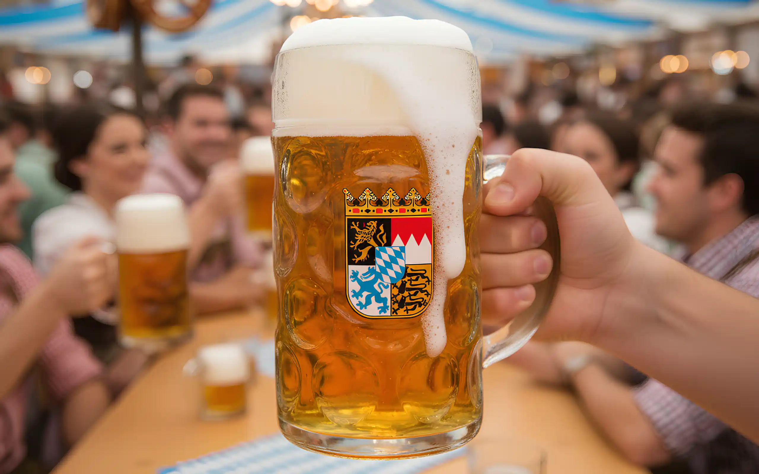 raising a toast for oktoberfest in a glass dimpled german beer stein.