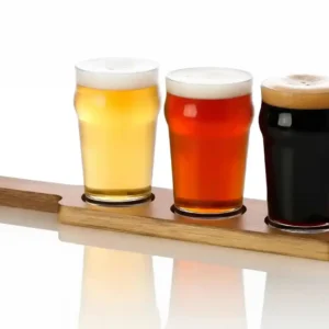 3 different beer samples in our 8oz mini nonic flight glasses on a wood paddle. white background.